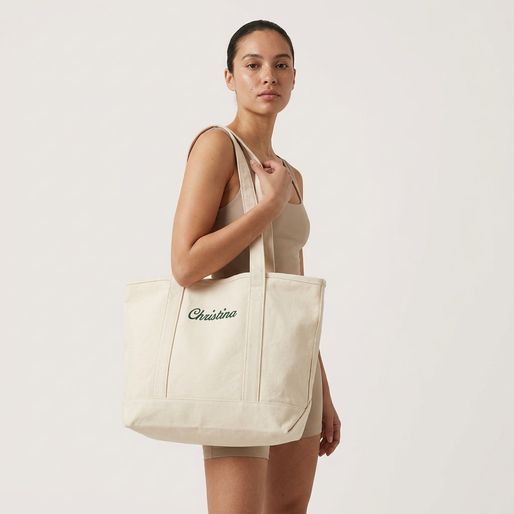 Model carrying a personalized tote bag with Christina embroidery